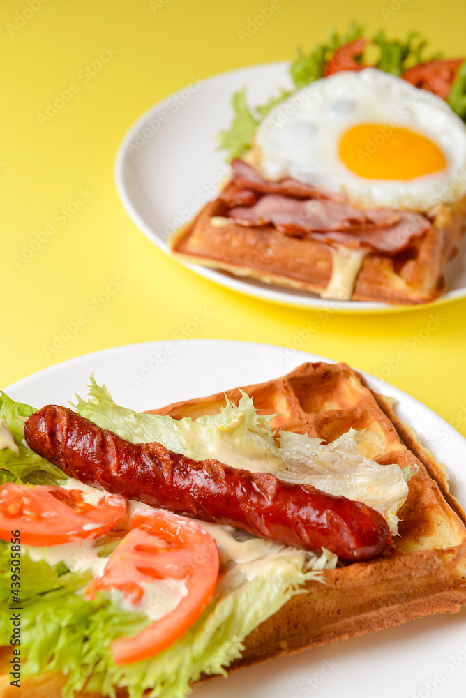 Waffle wholesome breakfast. Sour waffles with grilled sausages, fried eggs, delicious sauce and fresh vegetables. Waffle wholesome breakfast. Sour waffles with grilled sausages, fried eggs, delicious sauce and fresh vegetables.