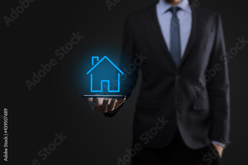 Real estate concept  businessman holding a house icon.House on Hand.Property insurance and security concept. Protecting gesture of man and symbol of house.