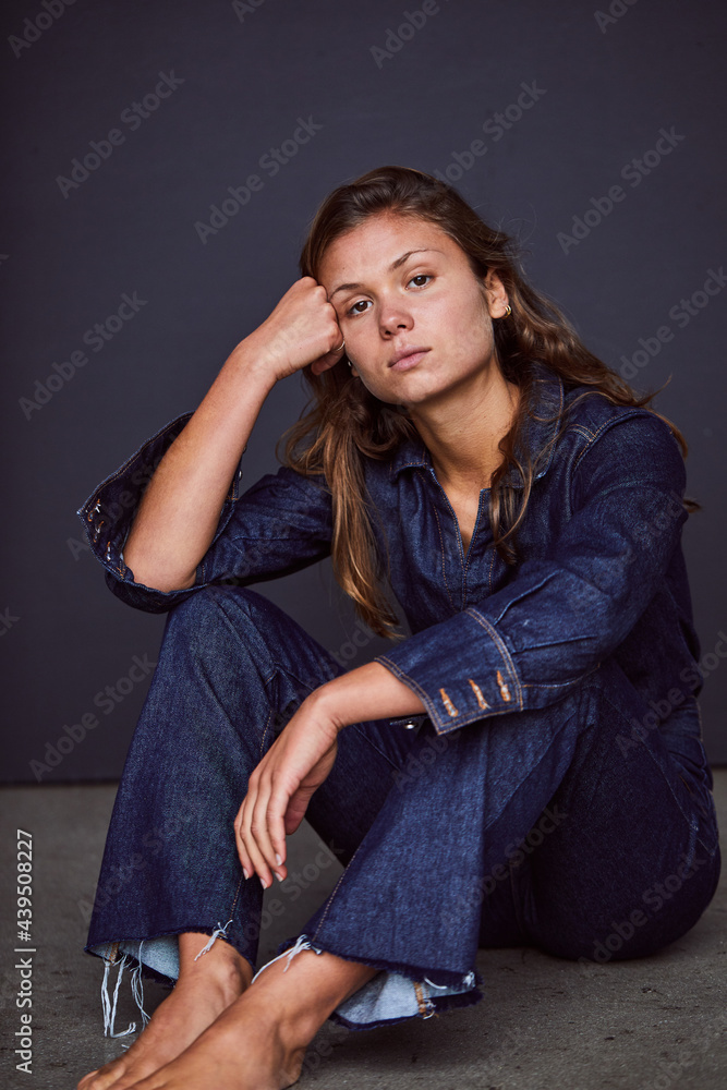 Woman in jumpsuit against a dark background Woman in jumpsuit against a dark background