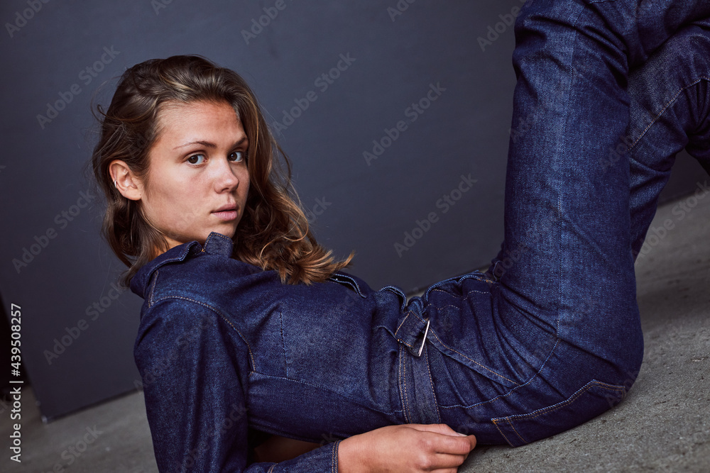 Stylish woman lying against a dark background Stylish woman lying against a dark background