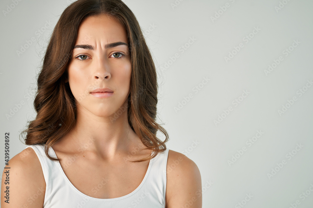 woman in white t shirt emotion displeased facial expression studio isolated background woman in white t shirt emotion displeased facial expression studio isolated background