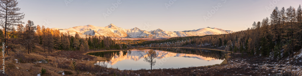 Autumn lakes, coniferous forests, snow-capped mountains. Panorama of the Altai Mountains in Russia.