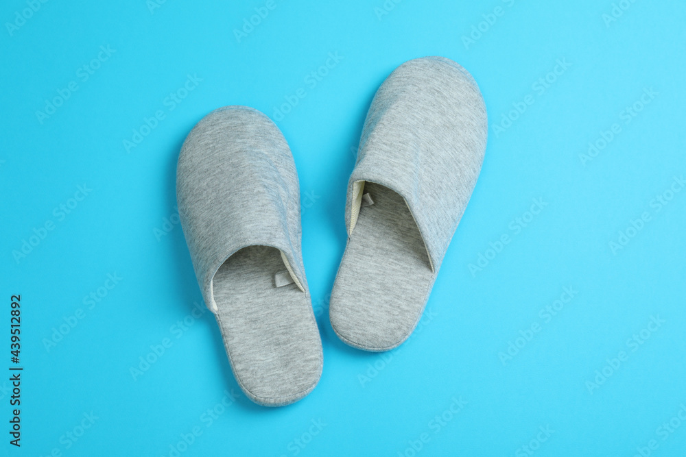 Pair of house slippers on blue background Pair of house slippers on blue background