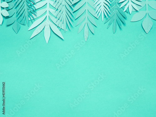 Summer background with colorful paper tropical leaves. © Kulbabka