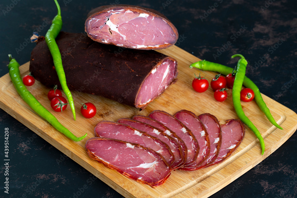 Turkish pastrami on a wooden serving plate. Pastrami is made from the