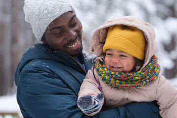 multiracial family having fun in the winter forest