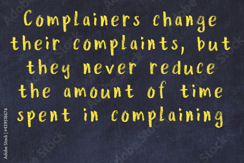 Chalk wise inscription on black chalkboard