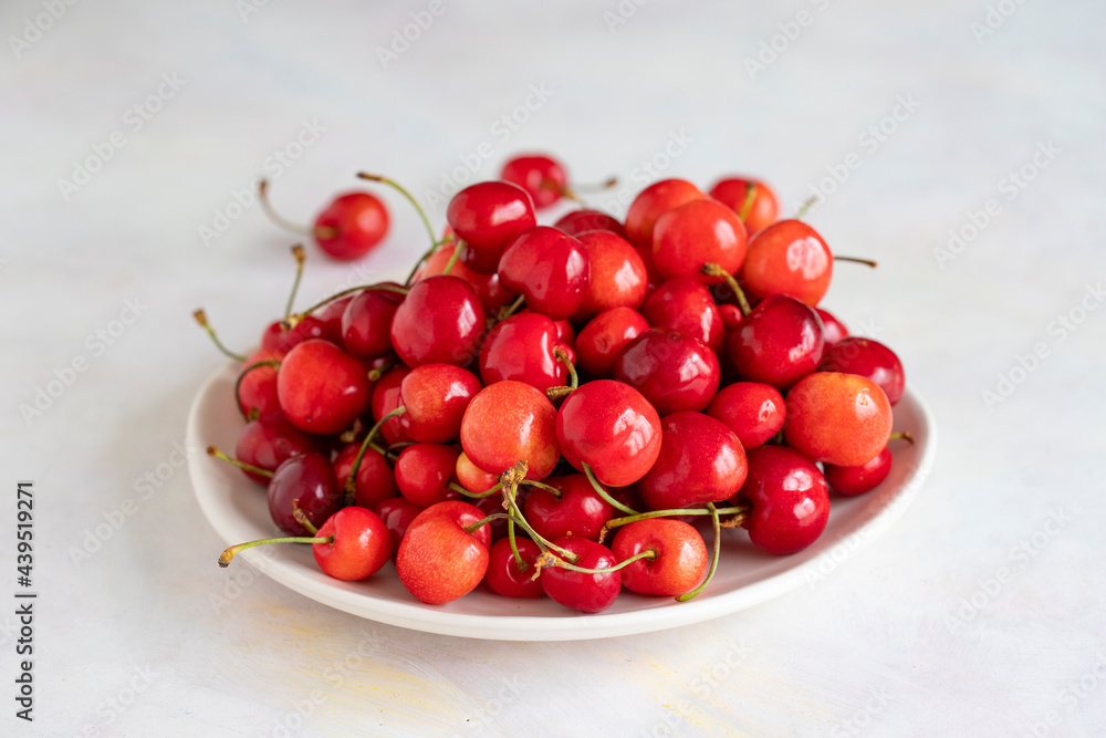 Ripe cherries on a white background. cherry on plate Ripe cherries on a white background. cherry on plate