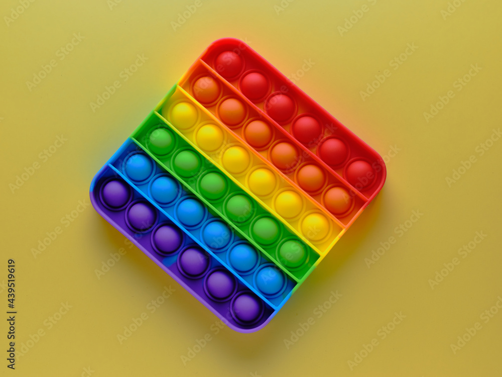 Pop It Simple Dimple. Popular anti-stress toy on a yellow background Pop It Simple Dimple. Popular anti-stress toy on a yellow background