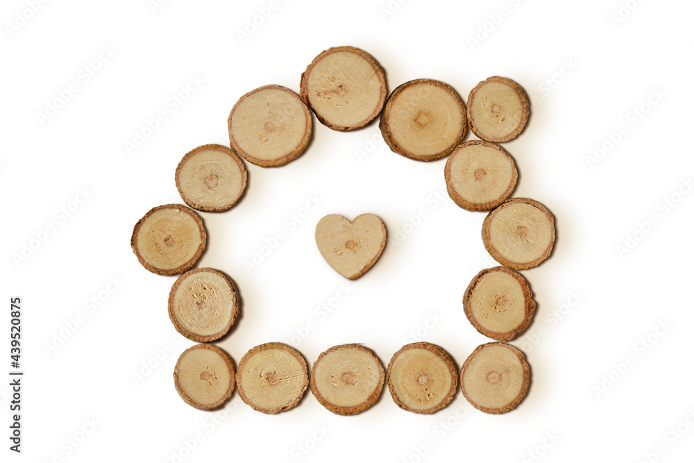 Home with heart made of wood slices on white background Home with heart made of wood slices on white background