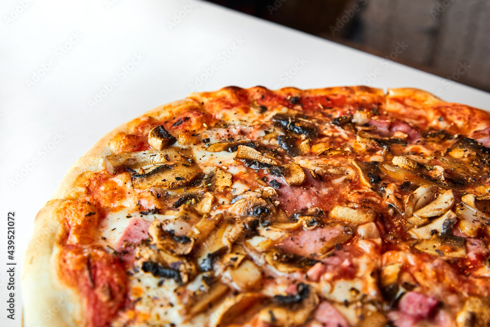 Fresh pizza with bacon, mushrooms and cheese on a light background. Close-up, selective focus Fresh pizza with bacon, mushrooms and cheese on a light background. Close-up, selective focus