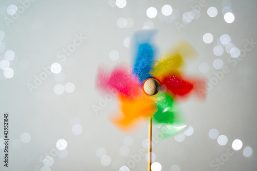 Colorful turning pinwheel on shiny white background