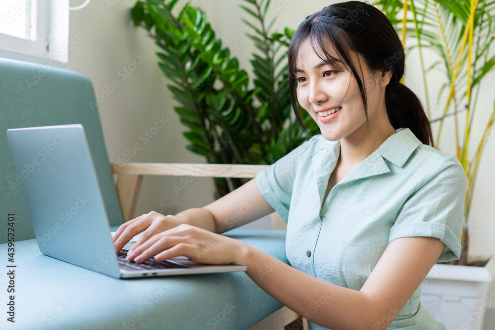 Young Asian woman working online from home Young Asian woman working online from home