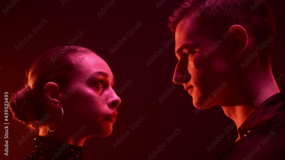 Ballroom dancers looking each other indoors. Dance couple holding hands inside. Ballroom dancers looking each other indoors. Dance couple holding hands inside.