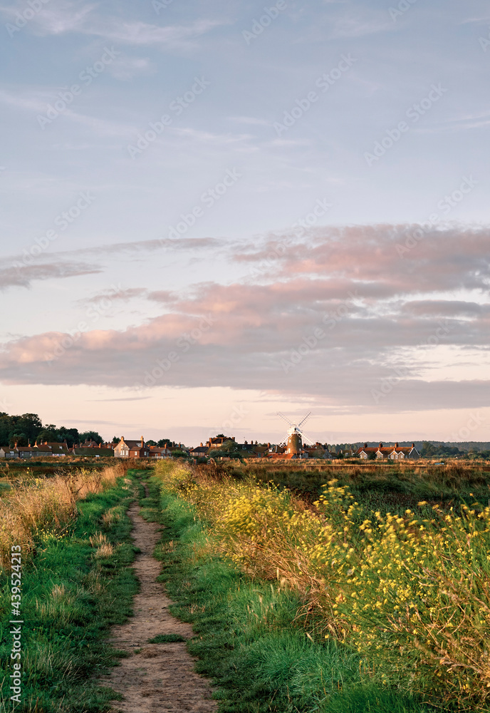 Sunrise over coastal footpath to Cley Windmill. Cley next the sea. Sunrise over coastal footpath to Cley Windmill. Cley next the sea.