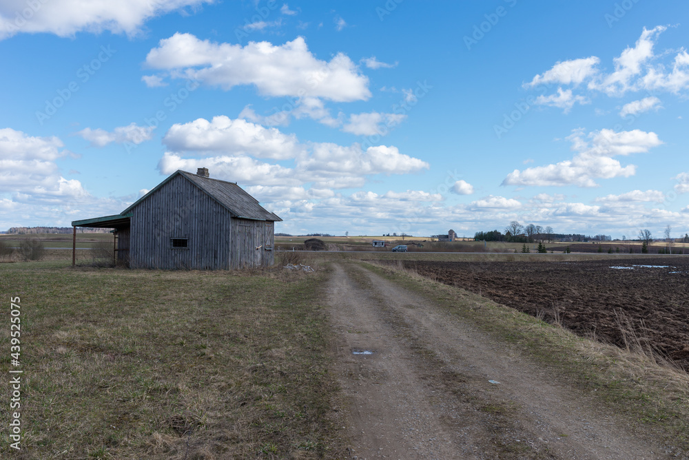 An old abandoned small wooden house in the fields sky clouds, barn or scary concept. An old abandoned small wooden house in the fields sky clouds, barn or scary concept.