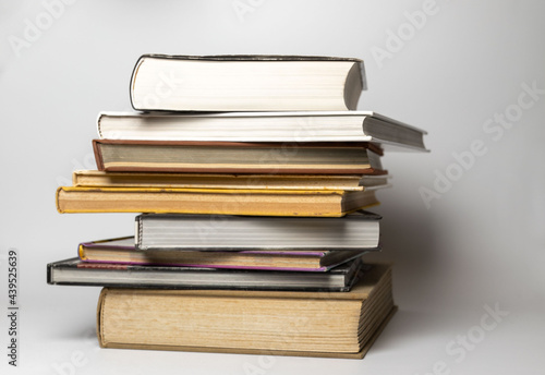 Pile of books in hard covers on a white background