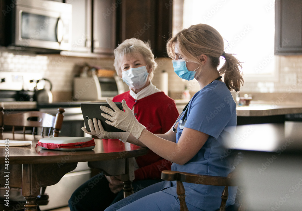 Health: Nurse Shows Senior Telehealth On Tablet Health: Nurse Shows Senior Telehealth On Tablet