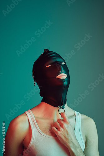 Young male wearing a gimp mask.
