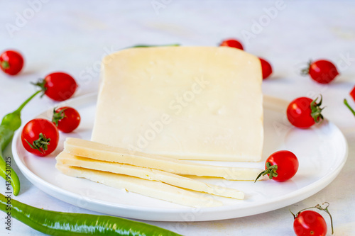 Old cheddar on a white plate. Sliced Cheddar Gruyere Cheddar. local name gravyer peynir photo