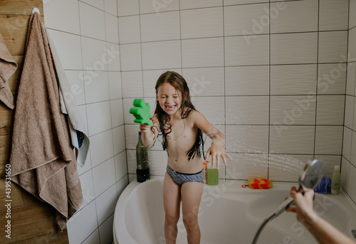 mother bathes her little daughter photo