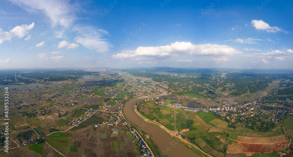 Beautiful sky, blue sky and white clouds. Green rice fields near the city of Shanghai, on the plain of the Yangtze River valley in China. Pictures of agricultural production and environmental protecti