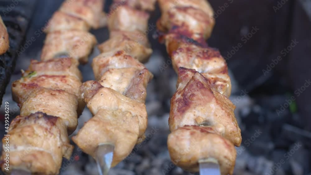 cooking meat on the grill on coals, fried shish kebab on skewers and grill cooking meat on the grill on coals, fried shish kebab on skewers and grill