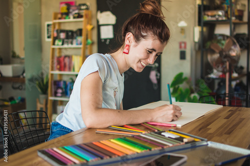 Woman smiling during an adult coloring book session photo