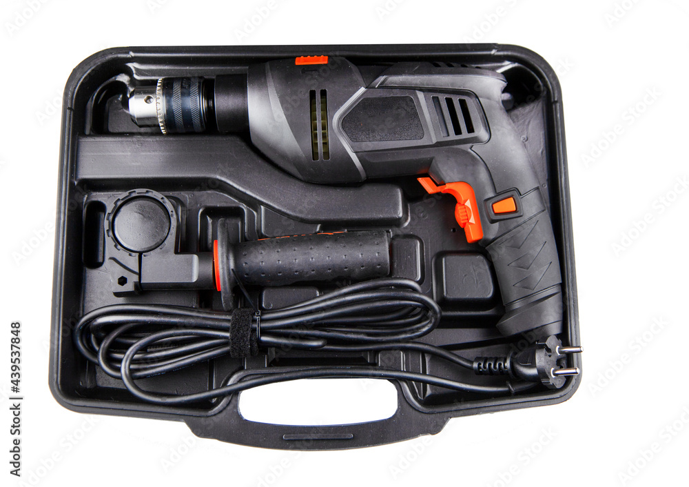 Electric drill in a suitcase. Keyless chuck. Gear teeth. Close-up tool. Metal details. Worker mechanics and tools Electric drill in a suitcase. Keyless chuck. Gear teeth. Close-up tool. Metal details. Worker mechanics and tools