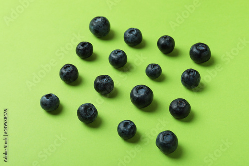 Fresh berry concept with blueberry on green background