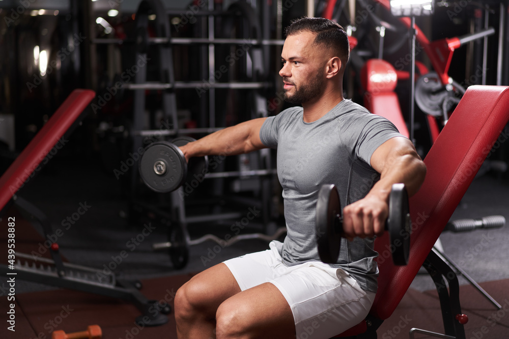 Bodybuilder doing shoulder workout Bodybuilder doing shoulder workout