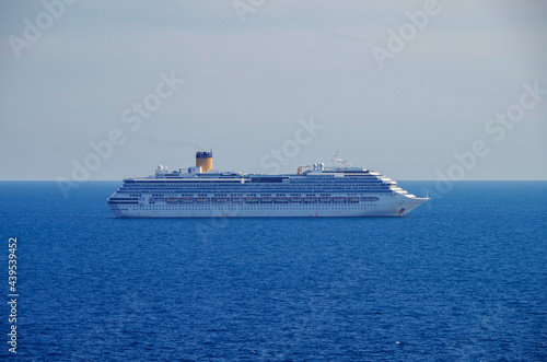 Costa cruiseships or cruise ship liners Pacifica, Fortuna and Favolosa anchored at sea offshore of Civitavecchia, Rome in Italy on sunny summer day with blue sky due to Corona Pandemic Pause photo