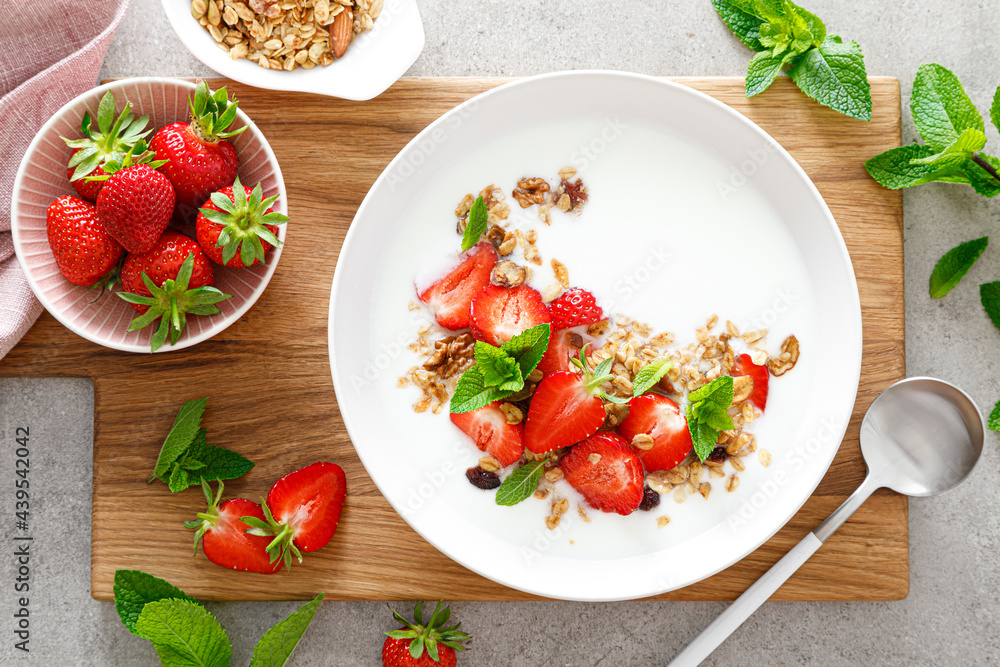 Strawberry granola with greek yogurt, nuts and fresh berries for breakfast, top view Strawberry granola with greek yogurt, nuts and fresh berries for breakfast, top view