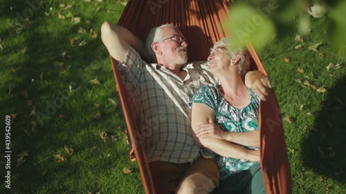 senior couple bonding on the hammock. free time together. positive retired people.