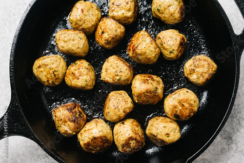 Chicken Shawarma Meatballs cooking in a cast-iron skillet photo