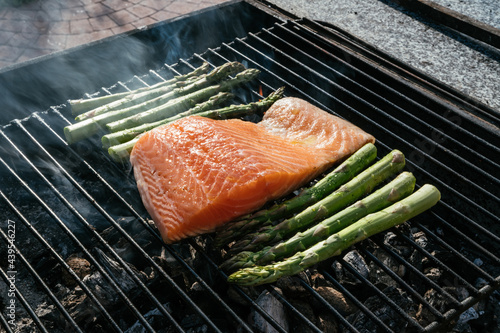 Fish and asparagus on grill grate photo