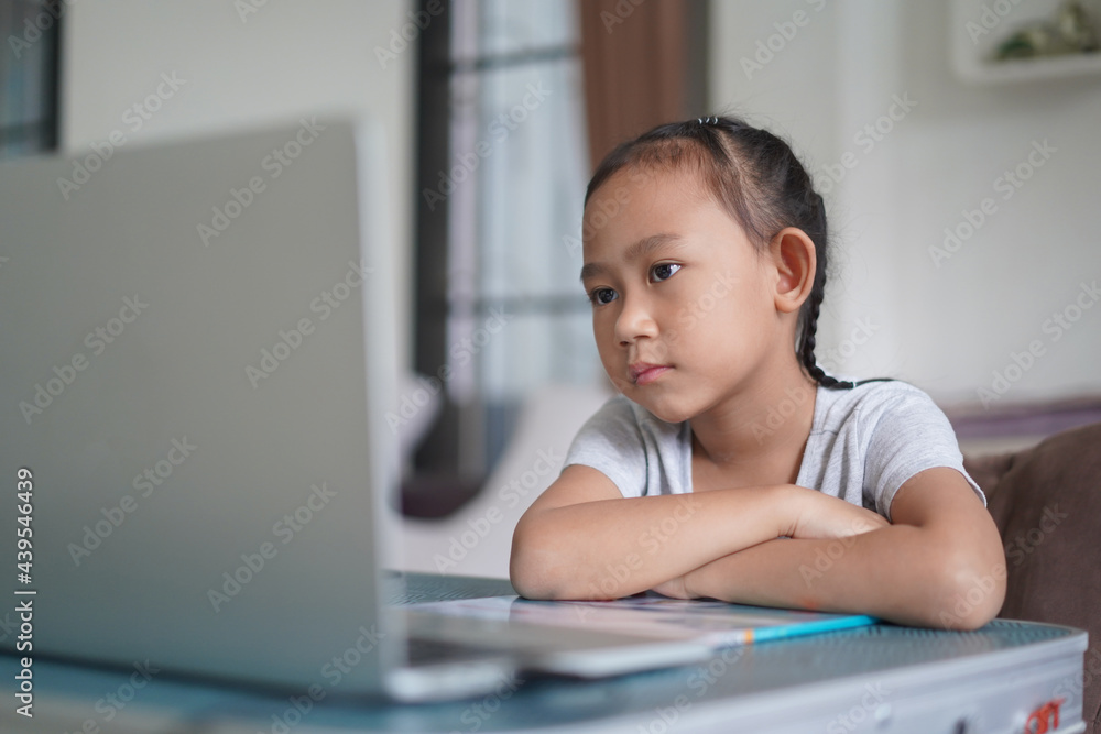 Asian little girl studying homework online lesson, Social distance online education at home idea concept Asian little girl studying homework online lesson, Social distance online education at home idea concept