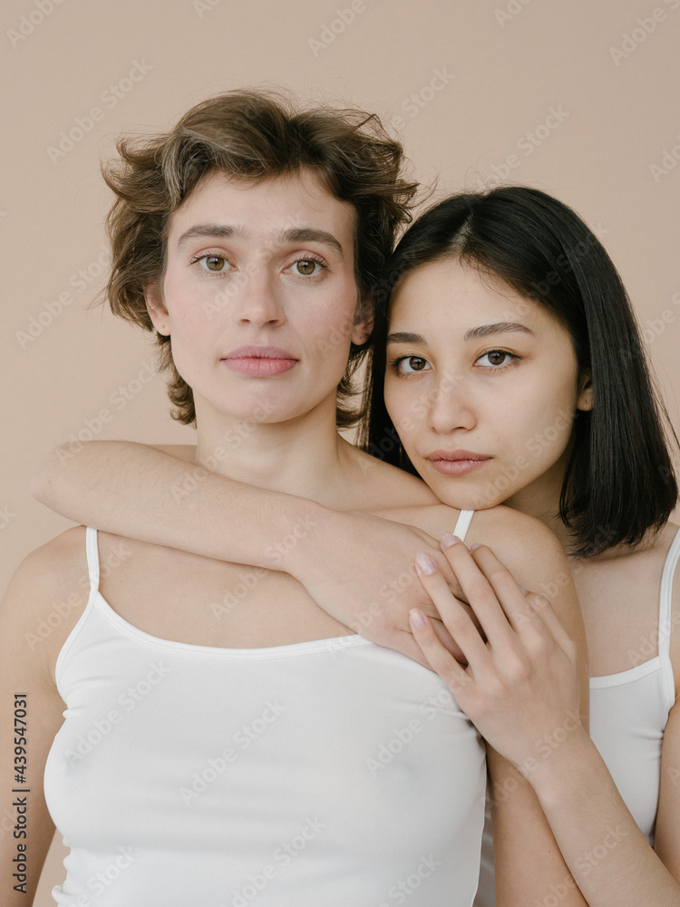 Middle age woman with short hairstyle and Young ethnic woman Middle age woman with short hairstyle and Young ethnic woman