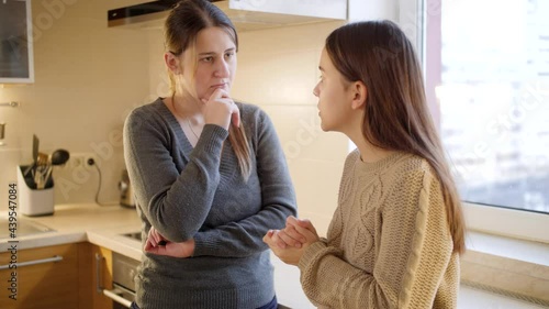Young mother listening and talking to her teenage daughter complaining about problems and depression. Parent supporting and comforting child