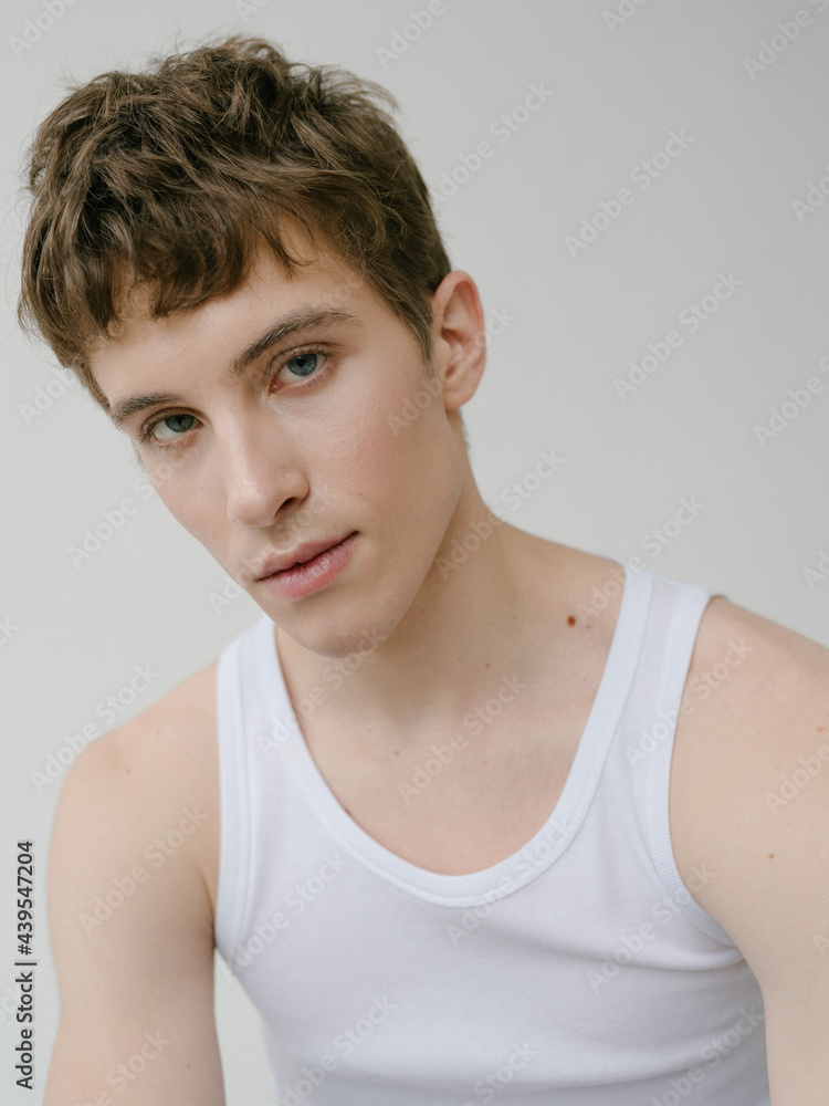 Young androgynous man looking at camera Young androgynous man looking at camera