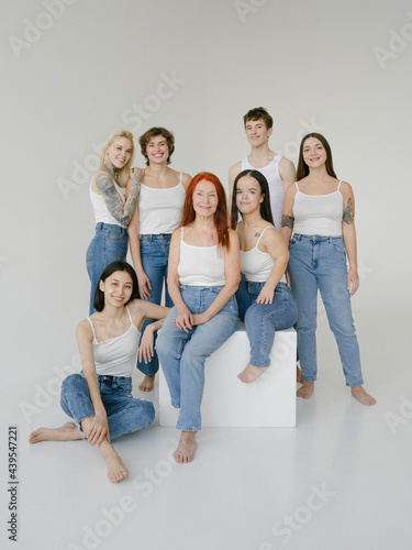 Group of diverse people in similar outfits in studio photo