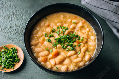 White beans soup topped with chives photo