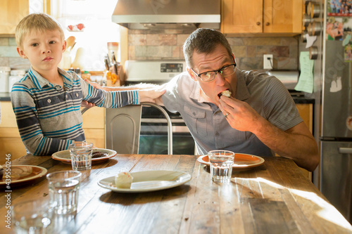 Father eats miniature cupcake photo