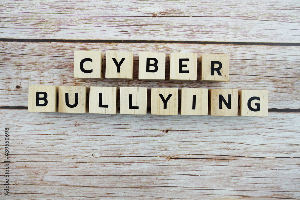 Cyber Bullying word alphabet letters on wooden background