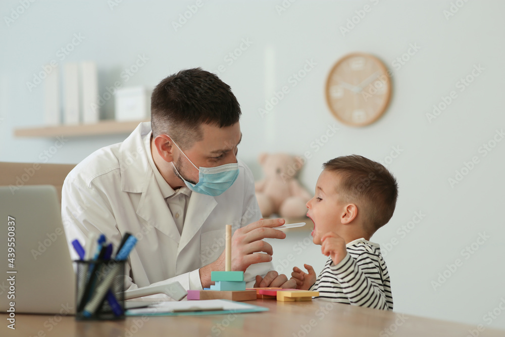 Pediatrician examining cute little boy at hospital Pediatrician examining cute little boy at hospital