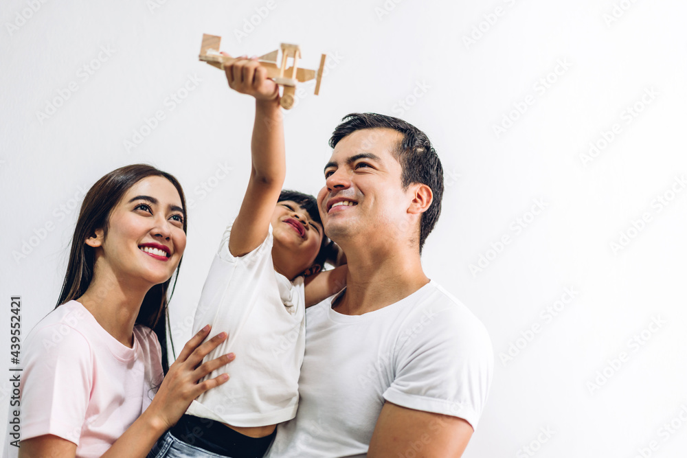 Portrait of enjoy happy love asian family father and mother holding cute little asian girl child smiling playing and having fun moments good time on white background at home Portrait of enjoy happy love asian family father and mother holding cute little asian girl child smiling playing and having fun moments good time on white background at home
