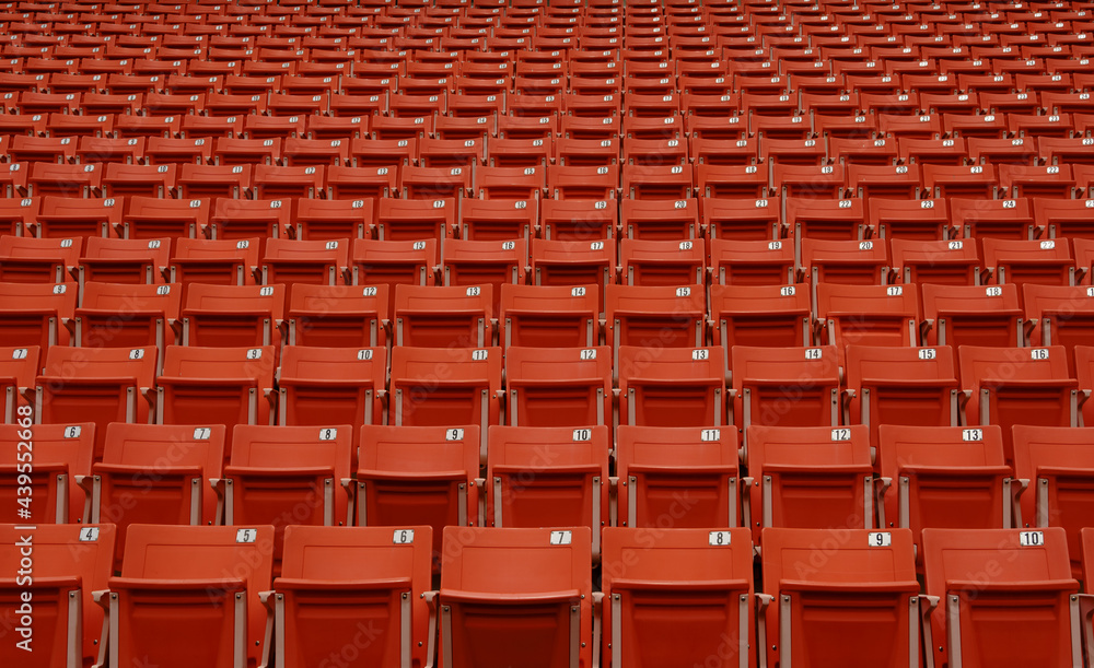 Fototapeta premium the emptiness of the seats in the football stadium,Red seats in a closed football stadium