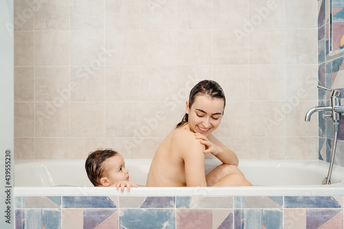 Mother and baby taking bath together photo