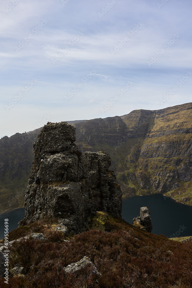huge rock on a mountain with a bottom lake in a valley. Comeragh Mountains, Waterford, Ireland