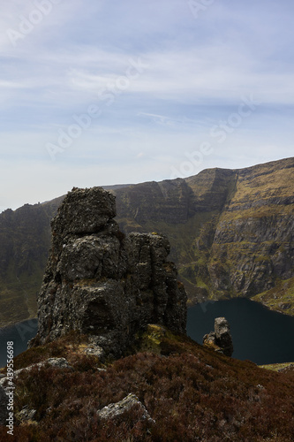 huge rock on a mountain with a bottom lake in a valley. Comeragh Mountains, Waterford, Ireland